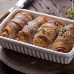Roladki schabowe w sosie, zawinięte w boczek, wyglądają soczyście. Kluczem do sukcesu jest odpowiednie przygotowanie, by nie były suche.
