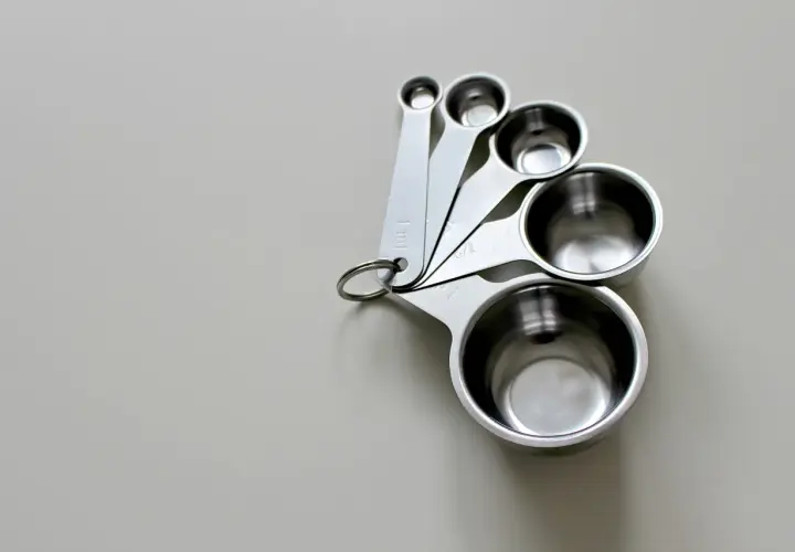 Zestaw metalowych miarek kuchennych. Pomogą Ci ustalić, ile ml oleju to gram, przyrządzając potrawy.