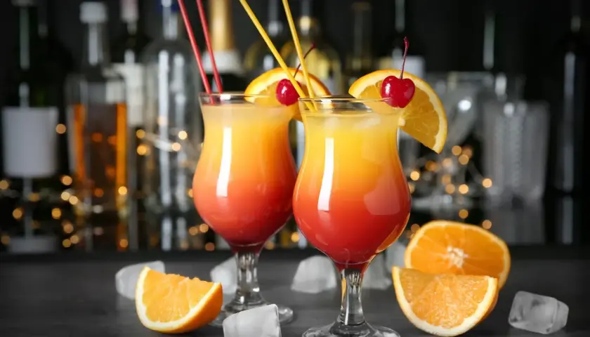 Dwa drinki z pomarańczą i wiśnią, idealne do nauki jak zrobić wódkę smakową.